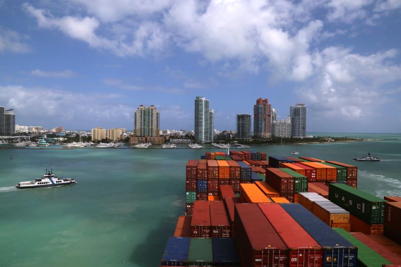 A container ship enters the Port of Miami facilitated by real-time data provided through PORTS®.